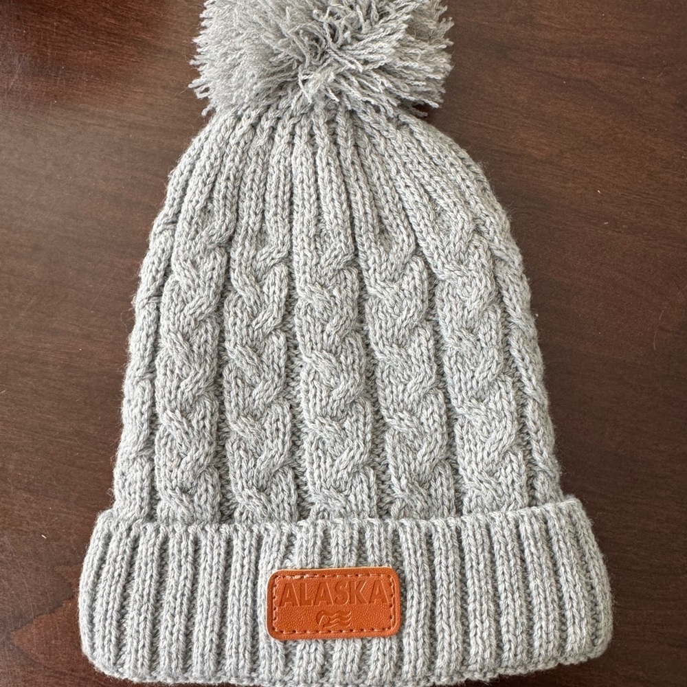 Gray Cable Knit Pom-Pom Hat with Alaska patch.
